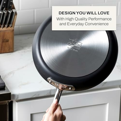 Person holding an All-Clad pan on a kitchen counter.