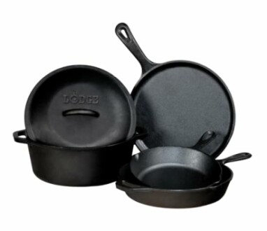 Set of cast iron cookware including pans and a Dutch oven.