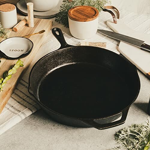 Backcountry Iron 12 Inch Round Large Pre-Seasoned Cast Iron Skillet on kitchen counter with utensils and herbs