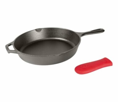 Cast iron skillet with red silicone handle cover.