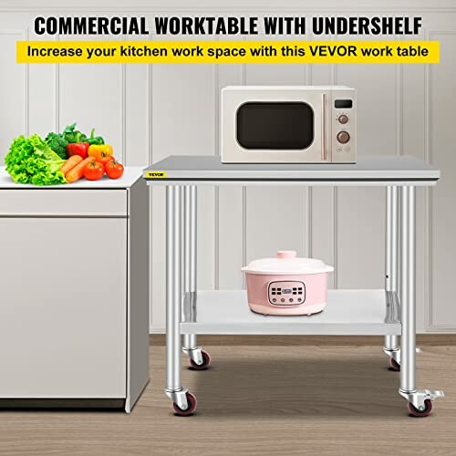 Commercial worktable with undershelf, featuring a microwave and rice cooker, with vegetables on the counter.
