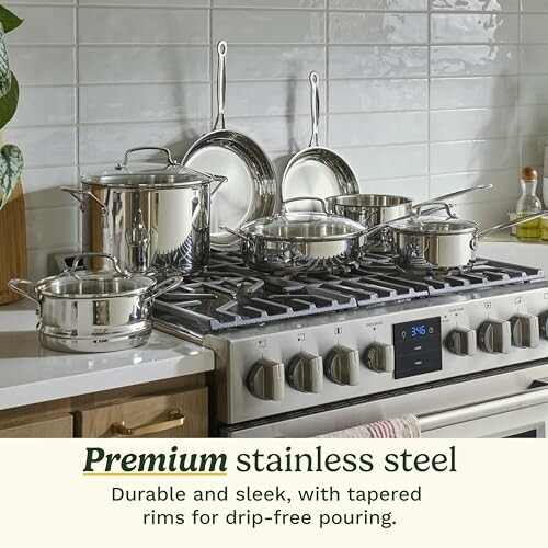 Stainless steel cookware set on a stove.