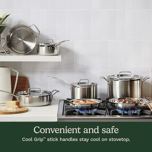 Stainless steel cookware set on kitchen stove.
